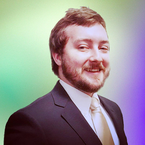 A photo of a smiling man wearing a smart suit